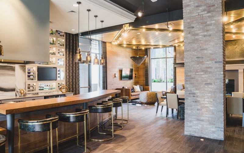 a large room with a bar and chairs