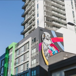 a large building with a mural of a bird