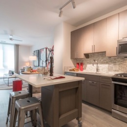 a kitchen with an island and chairs