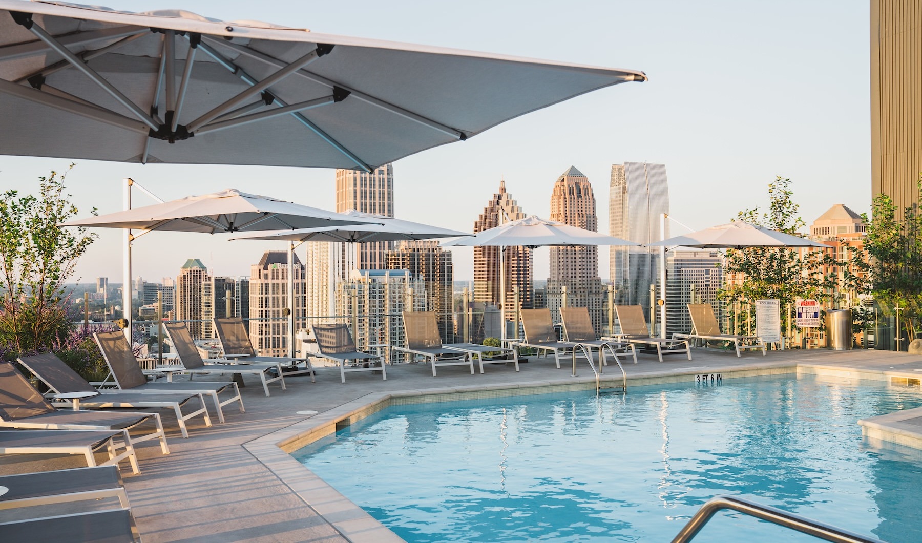 a swimming pool with lounge chairs