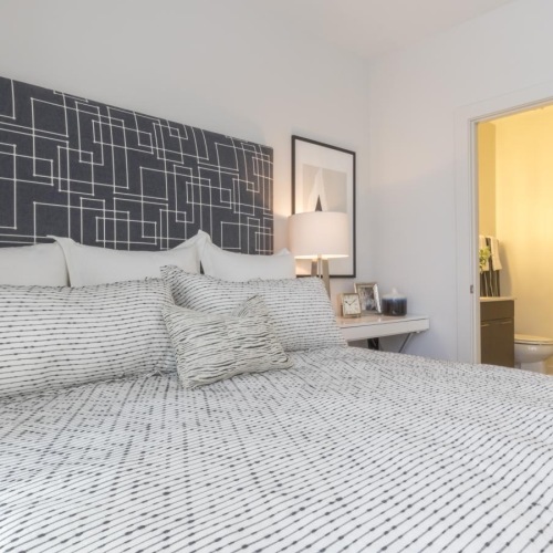 a bed with a white and black comforter