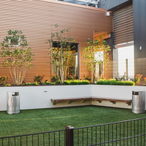 a fenced in yard with a house in the background